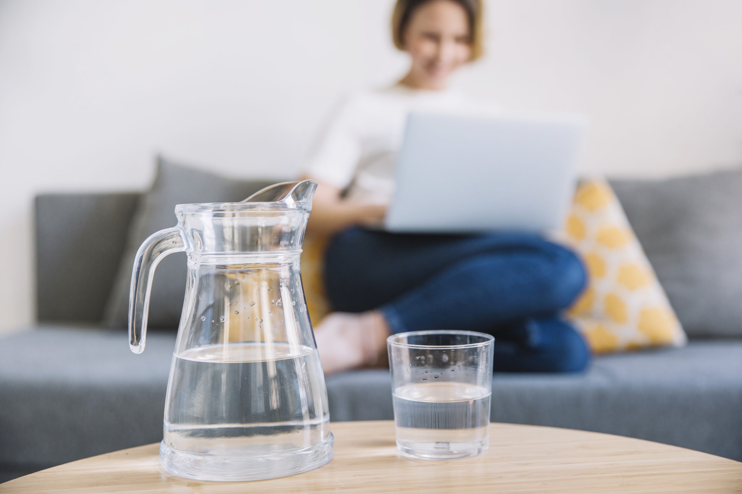 jug glass water near woman scaled